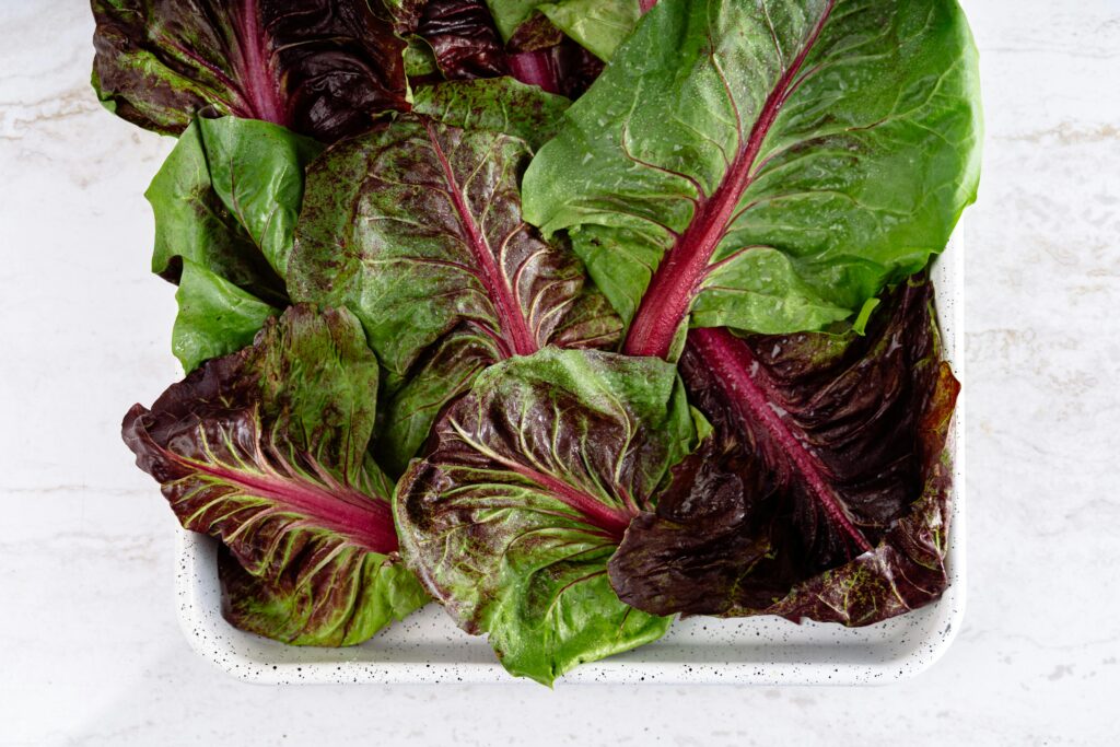Sautéed Swiss chard with olive oil in a pan, showing best preparation for anti-inflammatory benefits