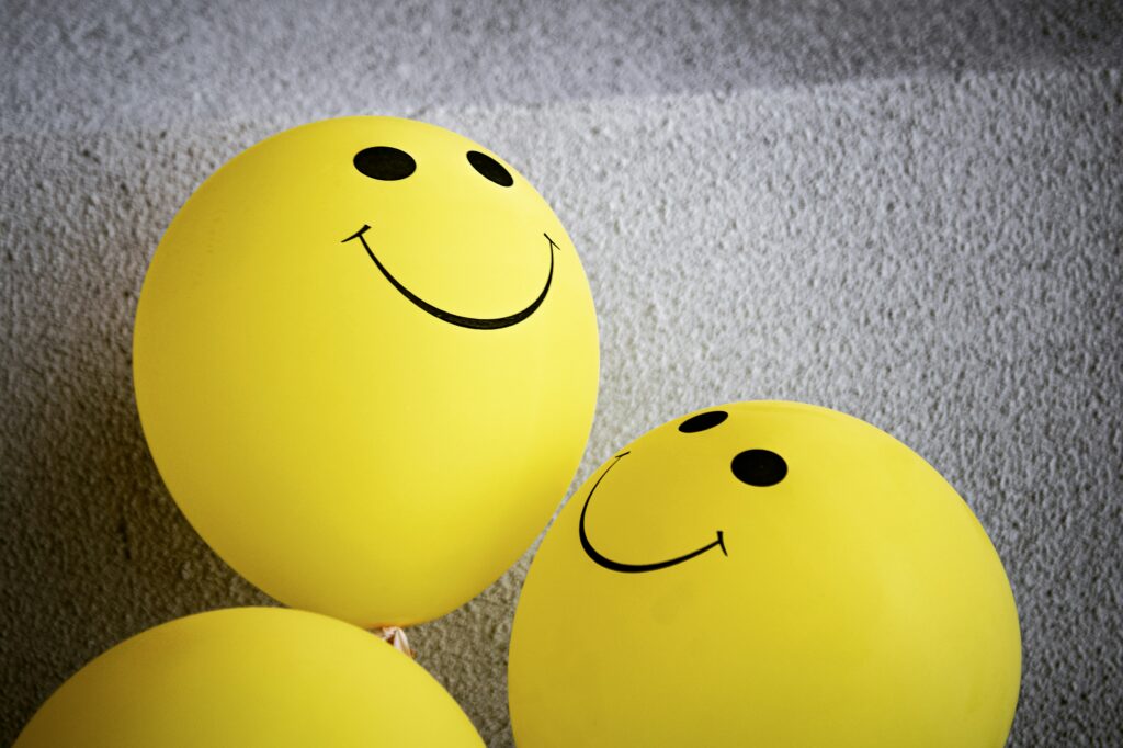 Baloons with a smily face representing comprehensive gut healing with moringa as one part of the approach